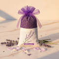 Sachet de lavande sur marbre avec bougies dorées et bouquet de lavande